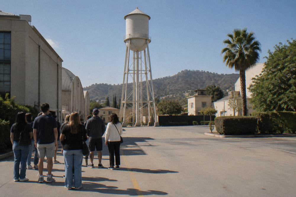 A tour group in front of the Warner Bros. water tower on a sunny afternoon